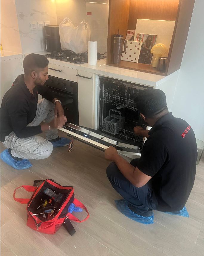 Technician completing an appliance repair and testing it