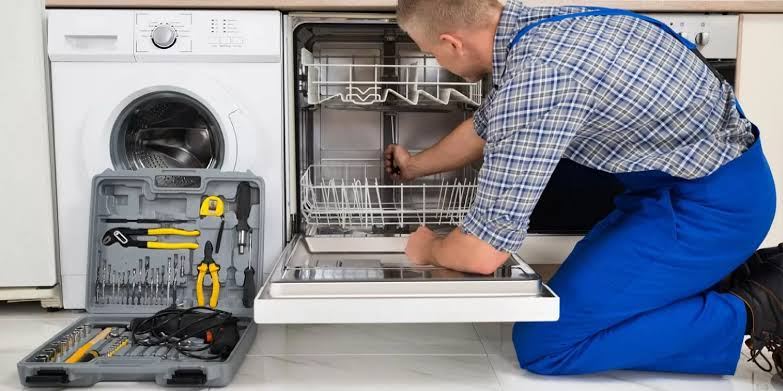 Dishwasher pulled out with a full technician toolkit