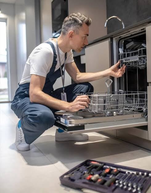 Technician working on an integrated dishwasher