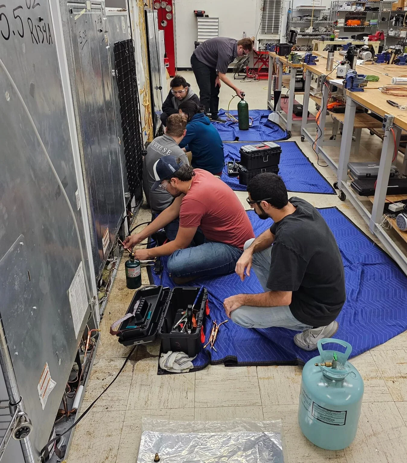 Refrigeration technicians working in the workshop