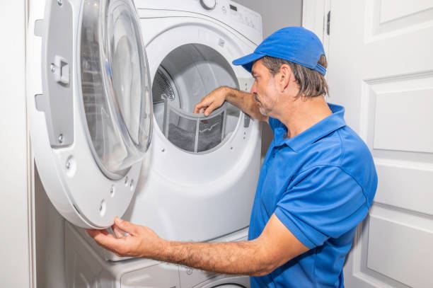 Technician servicing a tumble dryer lint filter
