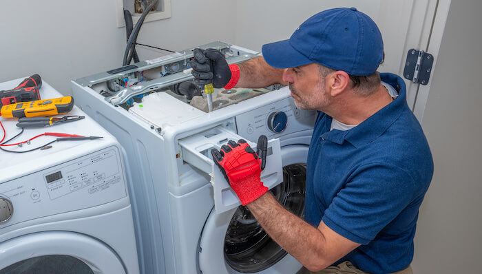 Technician testing a washing machine control panel