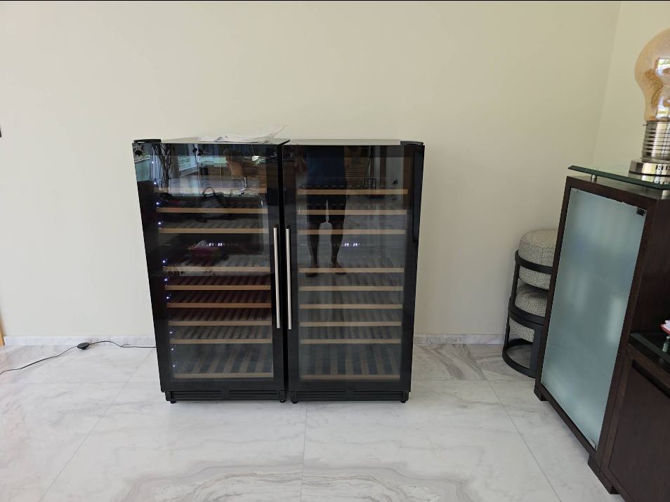 Technician servicing a wine cooler and chiller